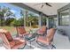 Inviting screened patio with comfortable seating, perfect for relaxing and enjoying the outdoors at 3136 Joshua St, Port Charlotte, FL 33948