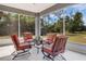 Inviting screened patio with comfortable seating, perfect for relaxing and enjoying the outdoors at 3136 Joshua St, Port Charlotte, FL 33948