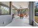Inviting screened patio with comfortable seating, perfect for relaxing and enjoying the outdoors at 3136 Joshua St, Port Charlotte, FL 33948