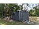 A gray metal shed sits on a grassy lot at 3136 Joshua St, Port Charlotte, FL 33948