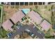 Overhead shot of condo complex featuring a central pool, lush greenery, tidy parking, and well-maintained roofs at 3221 White Ibis Ct # D2, Punta Gorda, FL 33950