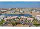 A captivating aerial view of the condo community showcasing waterways, nearby neighborhood, and Gulf in the distance at 3221 White Ibis Ct # D2, Punta Gorda, FL 33950