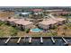 Aerial view of a condo community featuring a pool, boat docks, and beautiful landscaping near the water at 3221 White Ibis Ct # D2, Punta Gorda, FL 33950