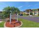 Well-maintained condo complex with lush landscaping, a community sign and ample parking on a clear sunny day at 3221 White Ibis Ct # D2, Punta Gorda, FL 33950