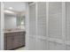 Bright hallway leads to a bathroom with granite vanity and features full mirrored closet at 3221 White Ibis Ct # D2, Punta Gorda, FL 33950