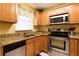 Cozy kitchen features granite countertops, wooden cabinets and stainless steel appliances at 3221 White Ibis Ct # D2, Punta Gorda, FL 33950