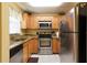 Charming kitchen with stainless steel appliances, granite counters, tile floors and light wood cabinets at 3221 White Ibis Ct # D2, Punta Gorda, FL 33950
