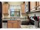 Granite countertops accent the kitchen with stainless steel appliances and wood cabinets at 3221 White Ibis Ct # D2, Punta Gorda, FL 33950
