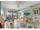 Bright living room with tile floors, a ceiling fan, neutral furniture, and sliding glass doors at 3221 White Ibis Ct # D2, Punta Gorda, FL 33950