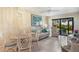 Comfortable living room featuring tile floors, neutral furniture, and a sliding glass door leading to a lanai at 3221 White Ibis Ct # D2, Punta Gorda, FL 33950