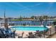 A fenced in in-ground pool overlooking the waterway is surrounded by patio furniture and an umbrella at 3221 White Ibis Ct # D2, Punta Gorda, FL 33950