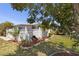 A well-maintained backyard featuring a white picket fence and lush green grass at 3305 Blue Jay Ln, Englewood, FL 34224