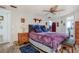 Cozy bedroom with unique bedding, a ceiling fan, and direct access to an ensuite bathroom at 3305 Blue Jay Ln, Englewood, FL 34224