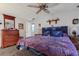 Comfortable bedroom with soft lighting, a dresser, and convenient access to an adjacent bathroom at 3305 Blue Jay Ln, Englewood, FL 34224