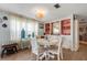 Bright dining area with a round table, comfortable seating, and custom built-in display cabinets at 3305 Blue Jay Ln, Englewood, FL 34224
