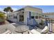 Charming home exterior with a deck and seating, offering relaxation and enjoyment of outdoor living at 3305 Blue Jay Ln, Englewood, FL 34224