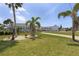 Charming single-story home with beautiful landscaping, palm trees and a well-maintained lawn at 3305 Blue Jay Ln, Englewood, FL 34224
