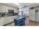 Charming kitchen with custom cabinets, granite countertops, backsplash, and seamless access to dining at 3305 Blue Jay Ln, Englewood, FL 34224