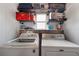 Functional laundry room with washer, dryer, shelving, and ample storage space at 3305 Blue Jay Ln, Englewood, FL 34224