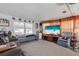 Bright living room with comfortable seating, a large TV, and plenty of natural light at 3305 Blue Jay Ln, Englewood, FL 34224