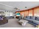 Spacious living room featuring plush seating, large windows, and a modern entertainment center at 3305 Blue Jay Ln, Englewood, FL 34224