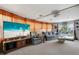 Inviting living room with a large TV, comfortable seating, and a view of the outdoor greenery at 3305 Blue Jay Ln, Englewood, FL 34224