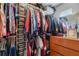Organized walk-in closet with shelving, hanging rods, and storage containers for optimal storage solutions at 3305 Blue Jay Ln, Englewood, FL 34224