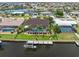 Aerial view of a waterfront home with a pool, private dock, boat lift, and tropical landscaping at 340 Belaire Ct, Punta Gorda, FL 33950