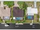 Aerial view showing a well-maintained property with a pool, dock, and boat lift on a canal at 340 Belaire Ct, Punta Gorda, FL 33950