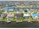 Aerial view displays the layout of homes along waterfront canals, each with private docks and backyard pools at 340 Belaire Ct, Punta Gorda, FL 33950