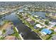 A wide aerial view displays waterfront homes with docks and boat lifts along winding canals in a residential neighborhood at 340 Belaire Ct, Punta Gorda, FL 33950