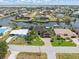 Aerial view shows a beautiful waterfront home with mature landscaping and access to the canal at 340 Belaire Ct, Punta Gorda, FL 33950