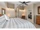 Comfortable bedroom featuring a ceiling fan, neutral walls and patterned bedding for a relaxing retreat at 340 Belaire Ct, Punta Gorda, FL 33950