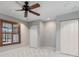 Bright bedroom featuring a fan, plantation shutters and a closet with sliding doors at 340 Belaire Ct, Punta Gorda, FL 33950