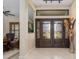Bright foyer featuring double glass doors and an open floor plan with tile flooring and modern lighting at 340 Belaire Ct, Punta Gorda, FL 33950