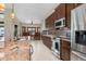 Gourmet kitchen featuring custom cabinetry, stainless steel appliances, and breakfast bar at 340 Belaire Ct, Punta Gorda, FL 33950
