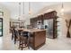 Open kitchen with granite countertops, stainless steel appliances, and breakfast bar seating at 340 Belaire Ct, Punta Gorda, FL 33950