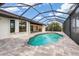 Inviting pool area with a screened enclosure and paved deck at 340 Belaire Ct, Punta Gorda, FL 33950