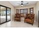 Bright sitting area featuring comfortable chairs and large glass sliding doors at 340 Belaire Ct, Punta Gorda, FL 33950
