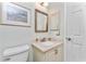 Bathroom vanity with sink, framed mirror, and white cabinets at 347 Coldeway Dr # G6, Punta Gorda, FL 33950