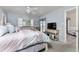 Comfortable bedroom featuring pastel bedding, TV, and sliding glass door leading to outdoor patio at 347 Coldeway Dr # G6, Punta Gorda, FL 33950