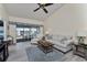 Bright living room with vaulted ceilings, fan, access to the screened patio and comfortable seating at 347 Coldeway Dr # G6, Punta Gorda, FL 33950