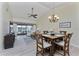 Open-concept living and dining area with access to the screened patio and vaulted ceilings at 347 Coldeway Dr # G6, Punta Gorda, FL 33950