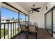 Screened-in patio featuring a ceiling fan and a table with seating, perfect for outdoor dining at 347 Coldeway Dr # G6, Punta Gorda, FL 33950