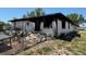 Exterior shot of a home with signs of fire damage and debris, and an overgrown lot at 3538 Pinetree St, Port Charlotte, FL 33952