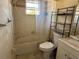 Bathroom with a shower-tub combo and shelving unit at 3538 Pinetree St, Port Charlotte, FL 33952