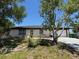 Modest one-story home with siding, an attached garage, and a yard in need of some TLC at 3538 Pinetree St, Port Charlotte, FL 33952