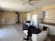 Interior shot of a living room with some damage, old cabinets, and an old refrigerator at 3538 Pinetree St, Port Charlotte, FL 33952