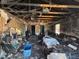 Living room damaged by fire with missing walls, burnt ceiling, and destroyed furniture at 3538 Pinetree St, Port Charlotte, FL 33952