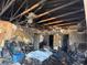 Living room damaged by fire with missing walls, burnt ceiling, and destroyed furniture at 3538 Pinetree St, Port Charlotte, FL 33952